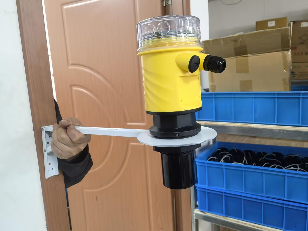 Ultrasonic level meter on a wall bracket mounting plate
